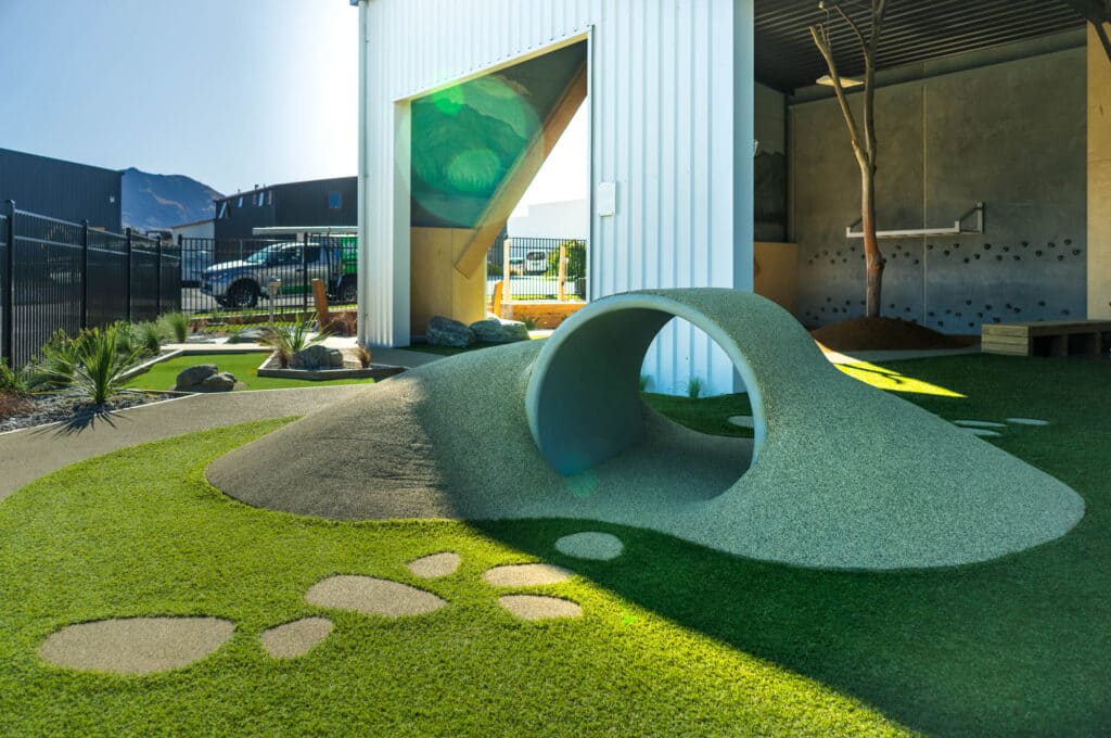 A childcare playground can have tunnels, mound and tracks.