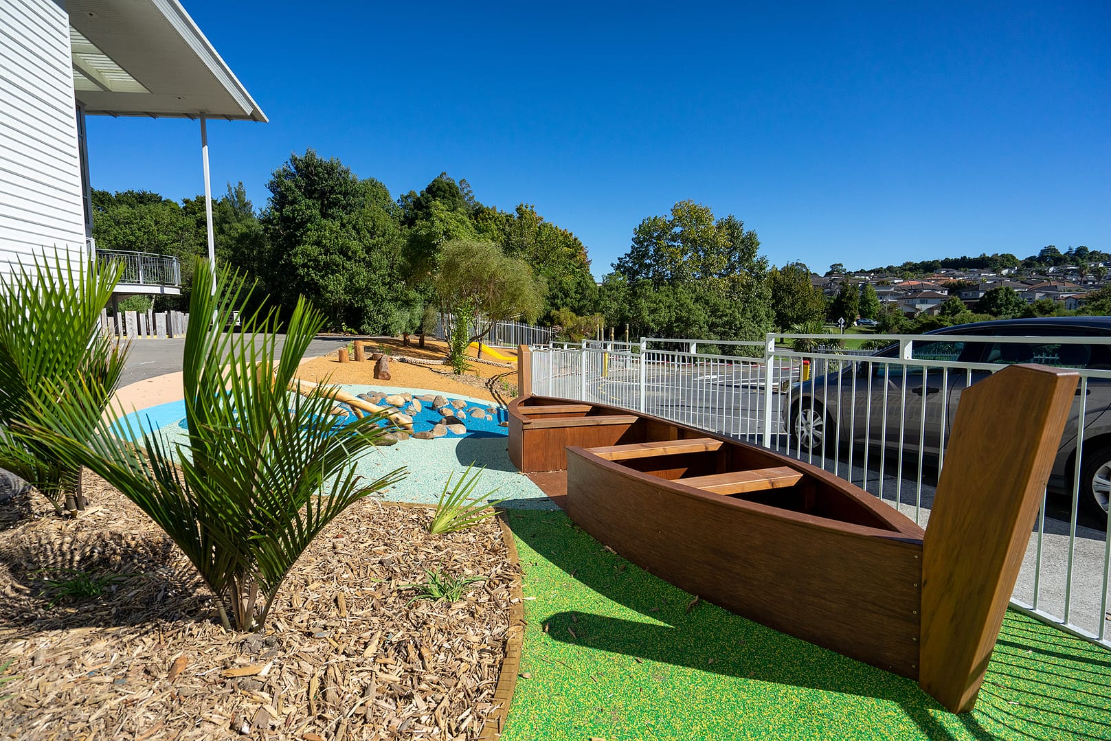 Playground with a boat, vegetation rubber and bark surface