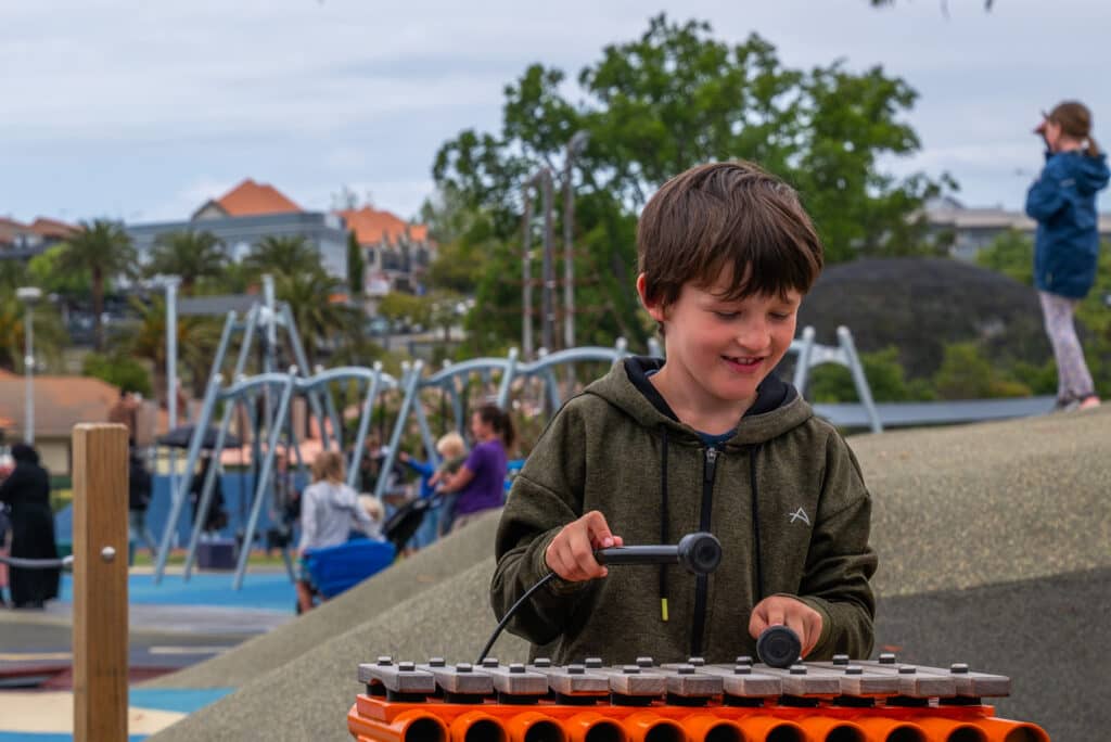 Child playing the xylophone.