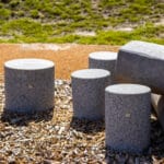 Playground surface with different material, some pillars in gray.