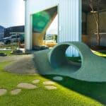 A childcare playground can have tunnels, mound and tracks.